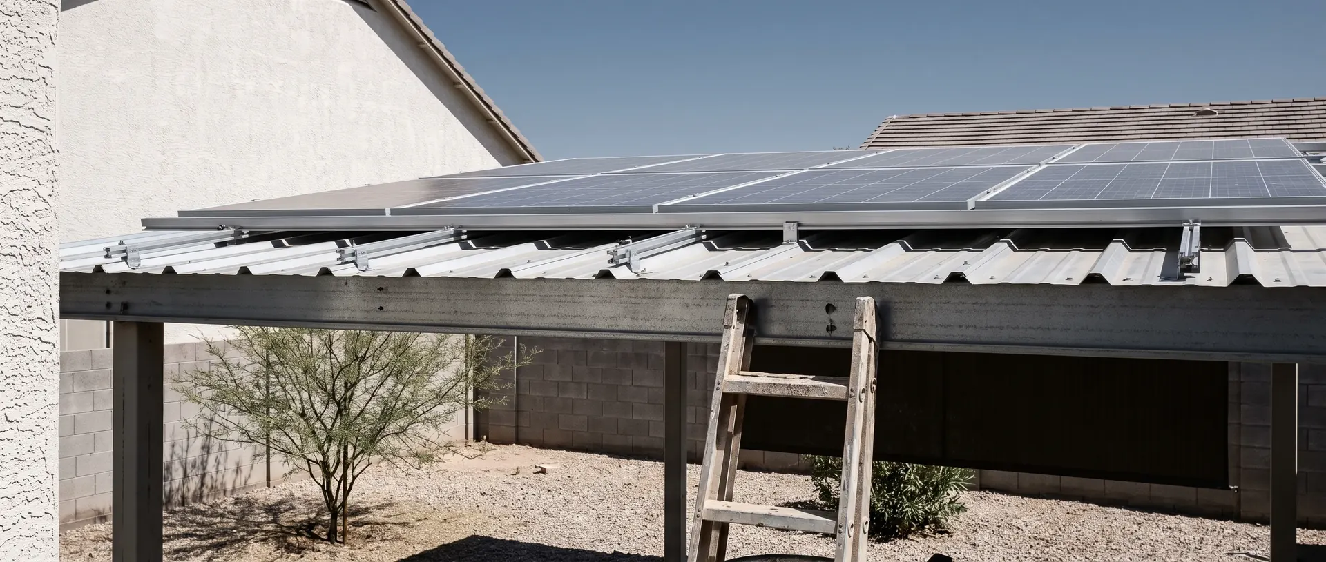 Solar panels mounted through a metal patio cover on a Chandler home