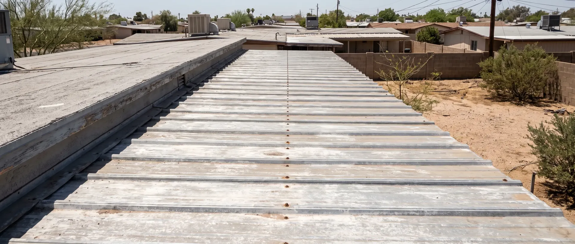 Weathered metal roof panels and fasteners on a Phoenix rooftop