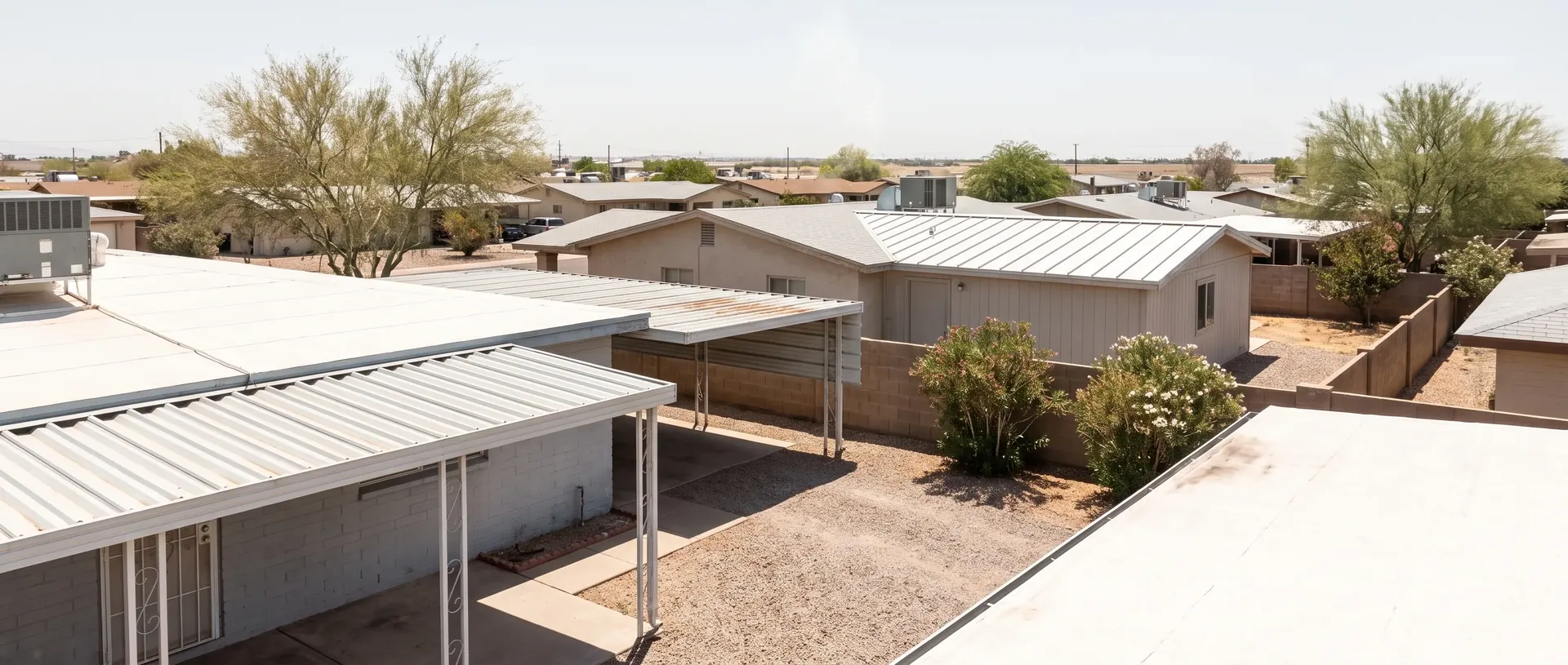 Low slope metal roofs, carports and patio covers across a metro Phoenix neighbourhood